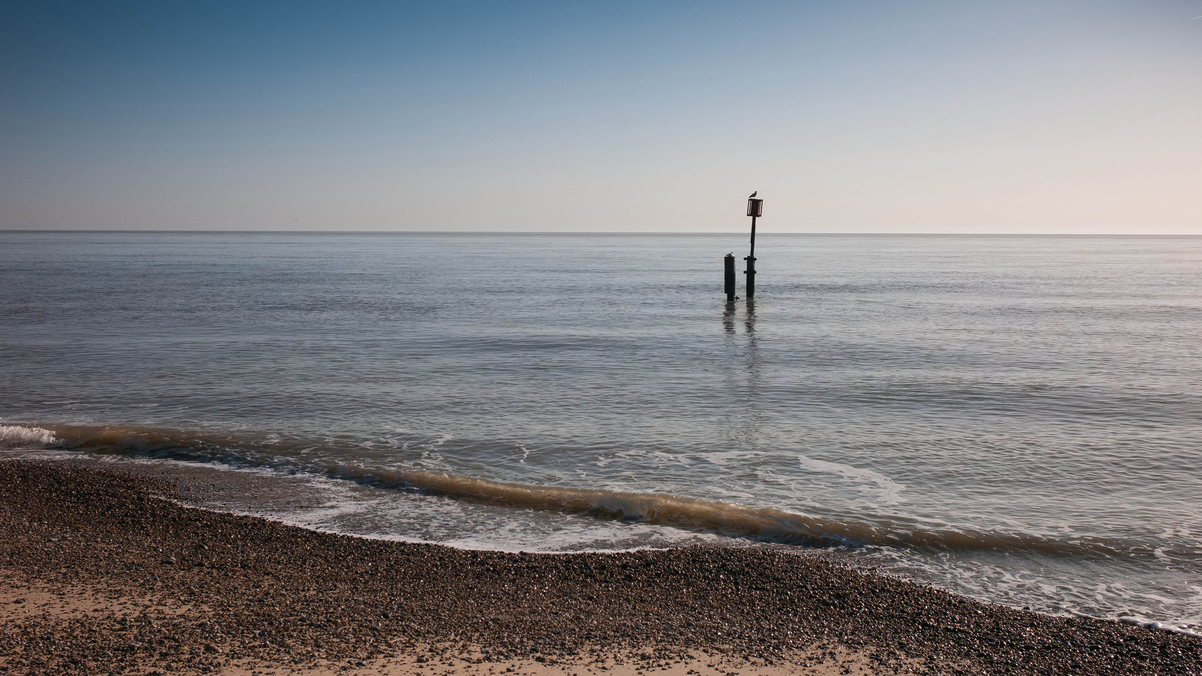 Seascape, shingle beach in the foreground with gentle waves from the sea